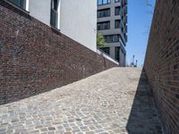 a sidewalk is shown with many bricks, with one light and the other shadow over it