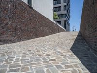 a sidewalk is shown with many bricks, with one light and the other shadow over it