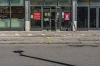 a fire hydrant stands in front of a store with a sign advertising a convenience