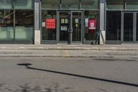 a fire hydrant stands in front of a store with a sign advertising a convenience