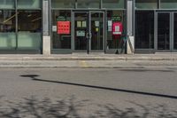 a fire hydrant stands in front of a store with a sign advertising a convenience