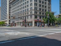 an intersection with buildings on both sides and a street light in the middle of the road