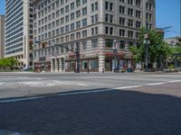 an intersection with buildings on both sides and a street light in the middle of the road