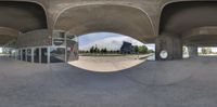 an empty building with a fish eye lens effect showing the space outside of it and it's windows