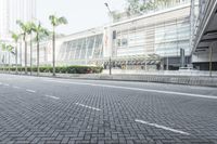 a black car driving down a road on top of bricks next to tall buildings,