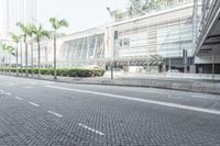 a black car driving down a road on top of bricks next to tall buildings,