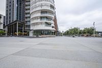 an urban square is full of modern architecture, including circular buildings and people riding bikes