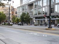 an empty street next to buildings and a bus stop sign with red and white numbers