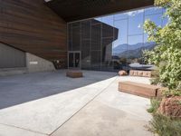 a person standing outside of a very nice building on a sunny day looking at their cell phone