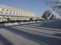 the buildings that line the walkway are designed like a wave and curves in front of them