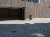 a building with doors and windows on it's sides with an open walkway and two fire hydrant in the center