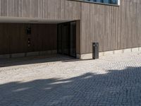 a building with doors and windows on it's sides with an open walkway and two fire hydrant in the center