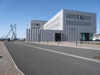 a very modern architecture and street in an empty city area under blue skies on a sunny day