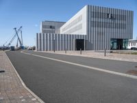 a very modern architecture and street in an empty city area under blue skies on a sunny day