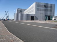 a very modern architecture and street in an empty city area under blue skies on a sunny day