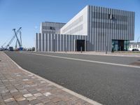 a very modern architecture and street in an empty city area under blue skies on a sunny day