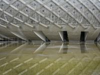 a very nice looking structure in water with no people standing in it with umbrellas