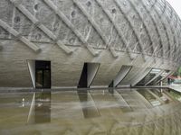 a very nice looking structure in water with no people standing in it with umbrellas