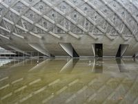 a very nice looking structure in water with no people standing in it with umbrellas
