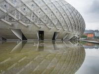 a very nice looking structure in water with no people standing in it with umbrellas