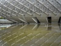 a very nice looking structure in water with no people standing in it with umbrellas