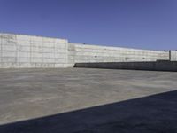 a concrete area with walls and floor tiles on it is pictured as the backdrop of the sky