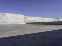 a concrete area with walls and floor tiles on it is pictured as the backdrop of the sky