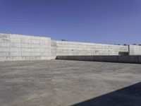 a concrete area with walls and floor tiles on it is pictured as the backdrop of the sky