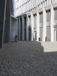 a building with three doors on one wall and a red fire hydrant on the other side