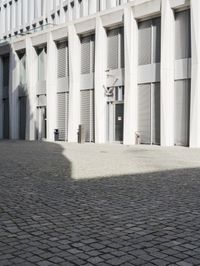 a building with three doors on one wall and a red fire hydrant on the other side