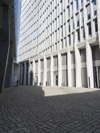 a building with three doors on one wall and a red fire hydrant on the other side