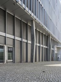 a building with three doors on one wall and a red fire hydrant on the other side