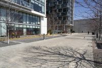 people walking down a sidewalk that has a red fire hydrant in the middle of it