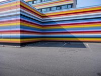 a colorful building painted to look like it's painted in stripes and colors of different colors