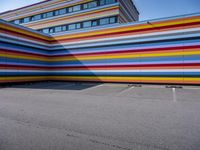 a colorful building painted to look like it's painted in stripes and colors of different colors