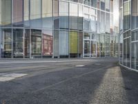 a person walking by a building on the street with no traffic or people visible in the photo