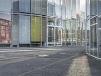 a person walking by a building on the street with no traffic or people visible in the photo