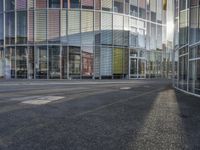 a person walking by a building on the street with no traffic or people visible in the photo