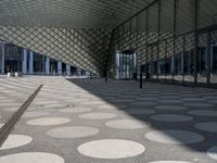a big building with a geometric design on the side of it that has white circles