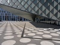 a big building with a geometric design on the side of it that has white circles