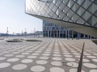 a big building with a geometric design on the side of it that has white circles