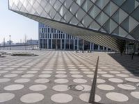a big building with a geometric design on the side of it that has white circles