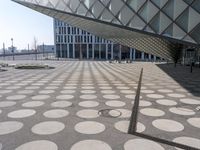 a big building with a geometric design on the side of it that has white circles