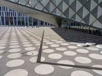 a big building with a geometric design on the side of it that has white circles