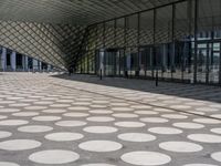 a big building with a geometric design on the side of it that has white circles