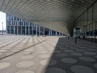 a big building with a geometric design on the side of it that has white circles