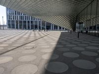 a big building with a geometric design on the side of it that has white circles