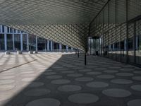 a big building with a geometric design on the side of it that has white circles
