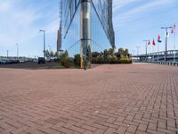 a bricked area with cars parked outside of it and the entrance to a business building behind