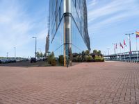 a bricked area with cars parked outside of it and the entrance to a business building behind